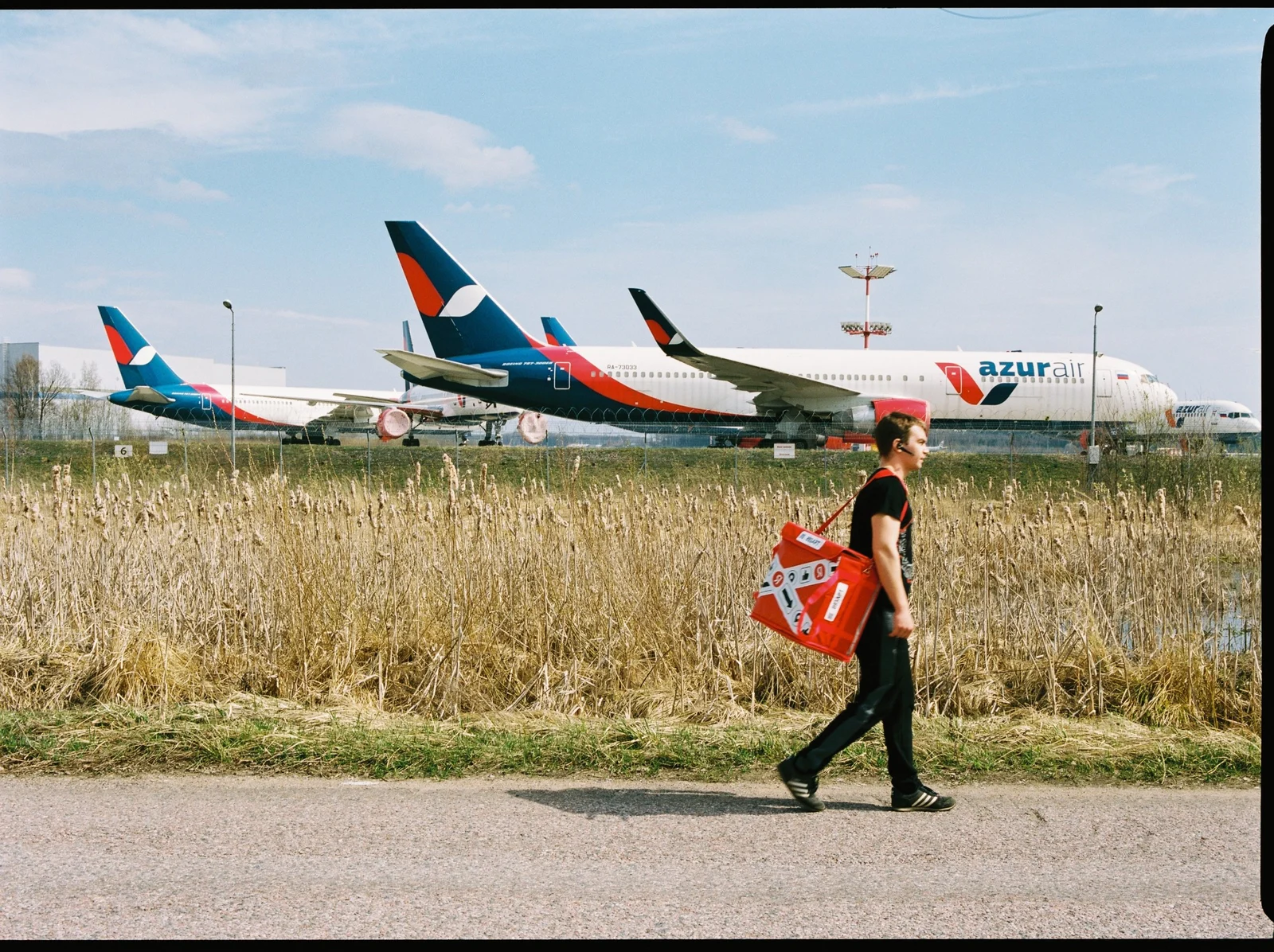 Courier walking past parked planes