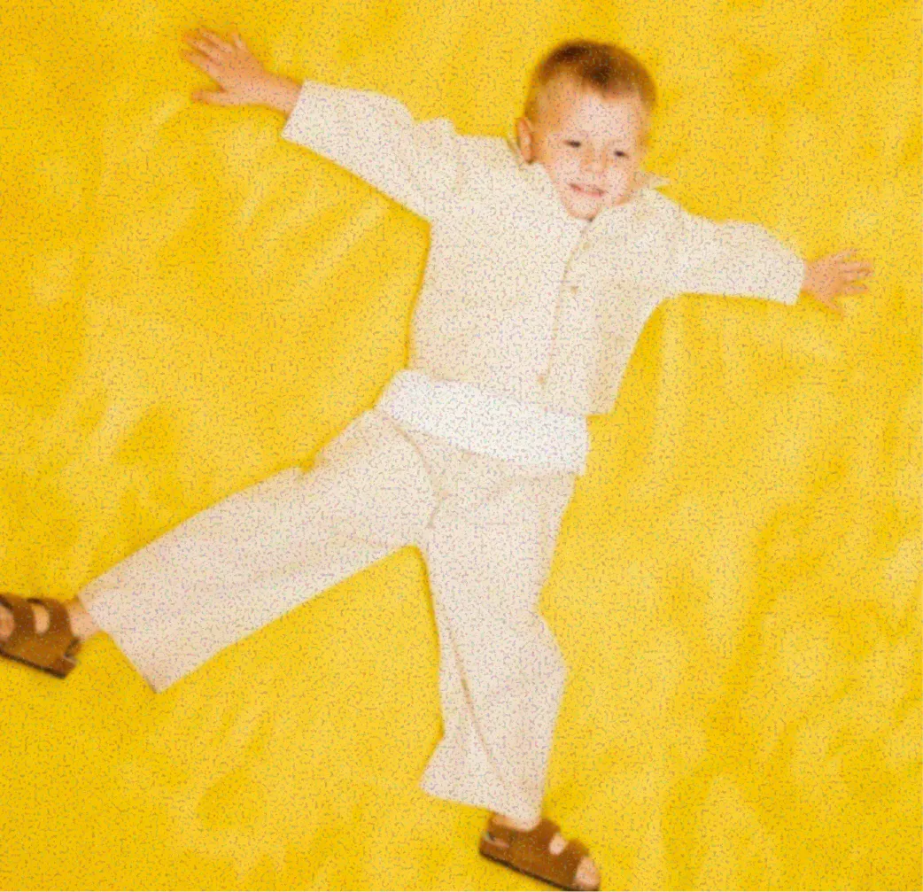 Child lying on a yellow rug